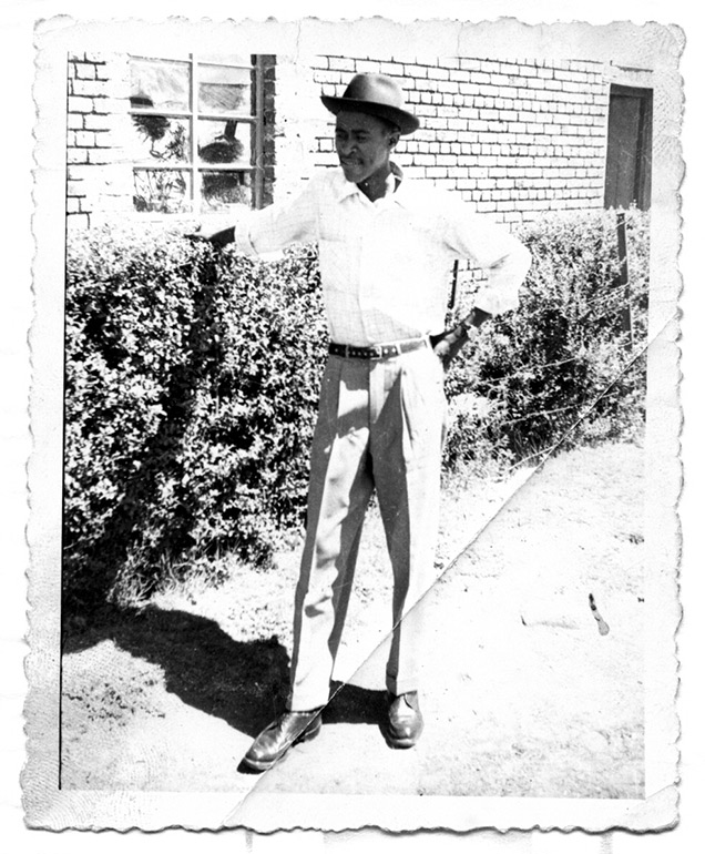 Mr-Jacob-Segoe-next-to-the-clipped-hedge-on-the-left-side-of-the-house